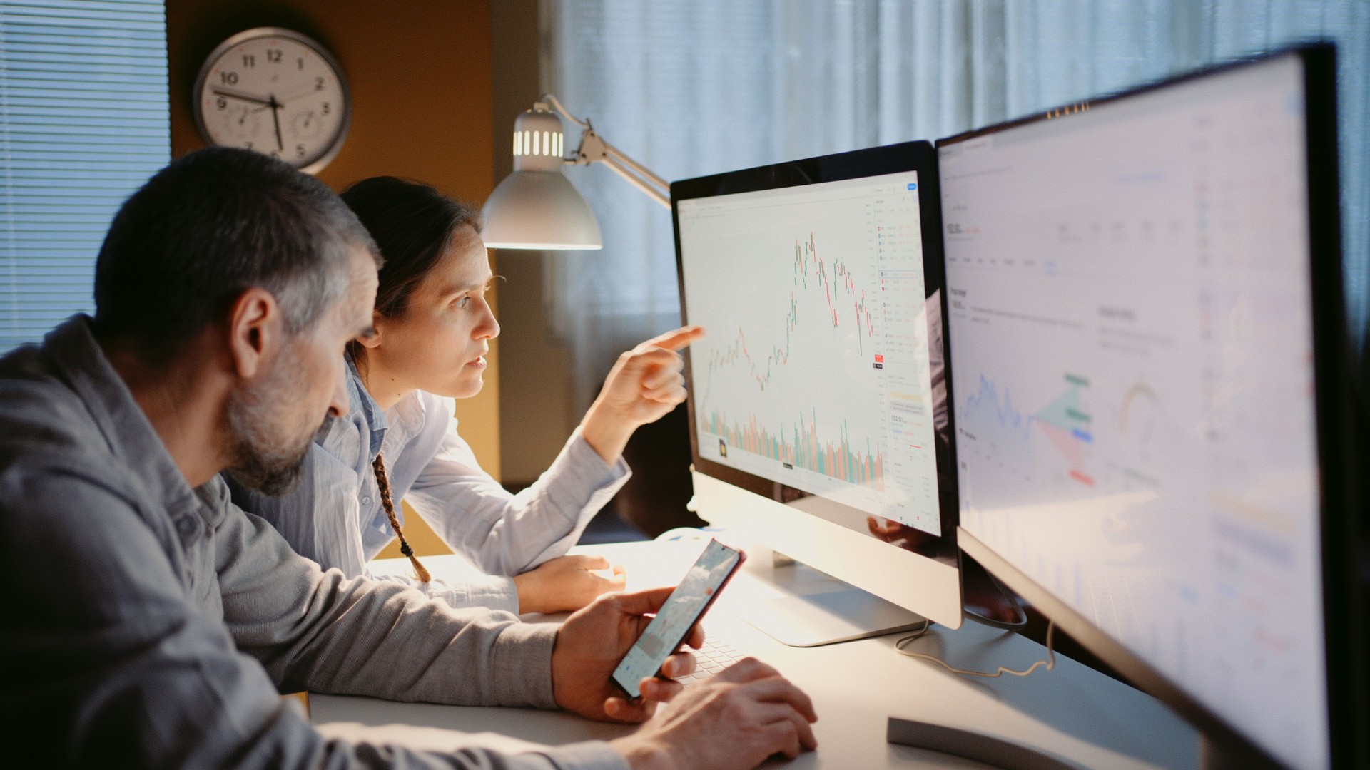 Stock trading. Family business. Using TradingView app at home office.